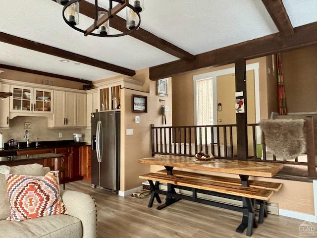 23 Townhouse Ln Unit D 1, Windham, NY 12496 - kitchen featuring stainless steel fridge, beam ceiling, a chandelier, light wood-style flooring, and baseboards