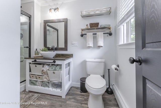 65 Lamb Ave, Saugerties, NY 12477 - bathroom featuring wood finished floors, vanity, baseboard heating, and a shower