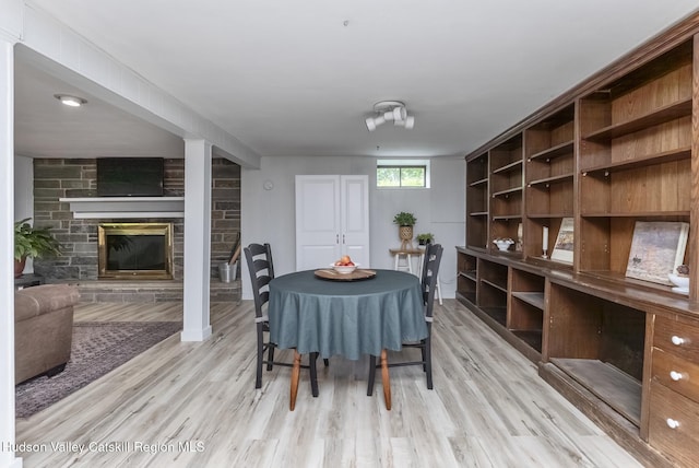 65 Lamb Ave, Saugerties, NY 12477 - dining space featuring light wood finished floors and a stone fireplace