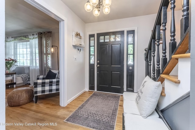 65 Lamb Ave, Saugerties, NY 12477 - entrance foyer with a chandelier, wood finished floors, and stairs