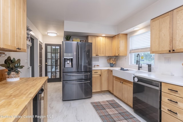 65 Lamb Ave, Saugerties, NY 12477 - kitchen with stainless steel fridge, dishwashing machine, light brown cabinets, light marble finish flooring, and wooden counters