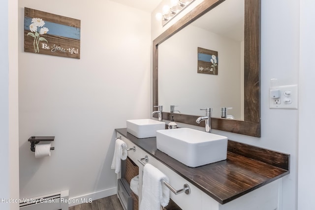 65 Lamb Ave, Saugerties, NY 12477 - bathroom with double vanity, wood finished floors, and a baseboard radiator