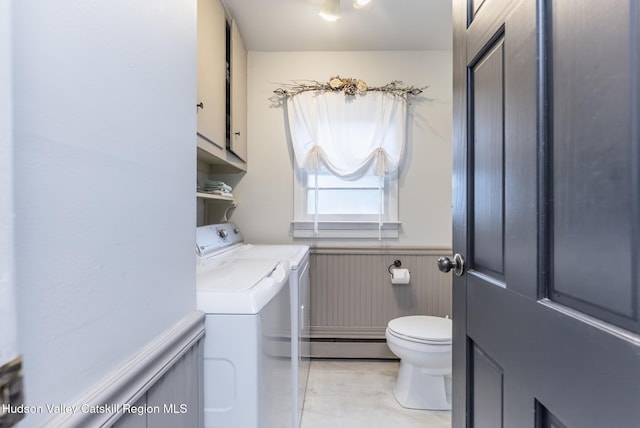 65 Lamb Ave, Saugerties, NY 12477 - bathroom featuring washing machine and clothes dryer, wainscoting, a baseboard radiator, and tile patterned flooring