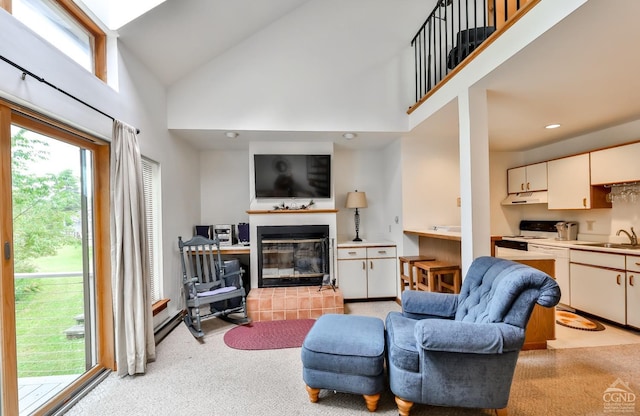 91 Windham Ridge Rd Unit 18B, Windham, NY 12496 - living area with light carpet, high vaulted ceiling, a glass covered fireplace, and recessed lighting