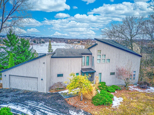 219 Sleepy Hollow Rd, Athens, NY 12015 - view of side of home with roof with shingles, a garage, and a mountain view