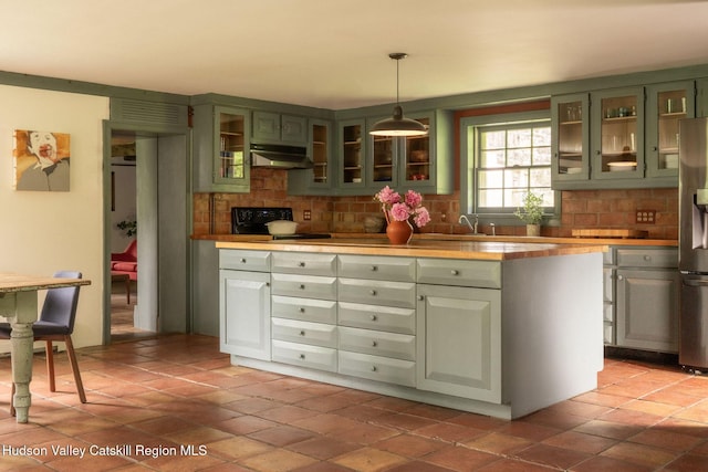 19 Dug Rd, Accord, NY 12404 - kitchen with green cabinets, under cabinet range hood, backsplash, stainless steel fridge with ice dispenser, and pendant lighting