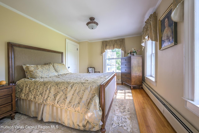 bedroom with a baseboard radiator, light wood finished floors, and ornamental molding