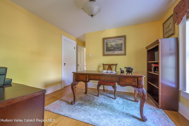 home office with wood finished floors