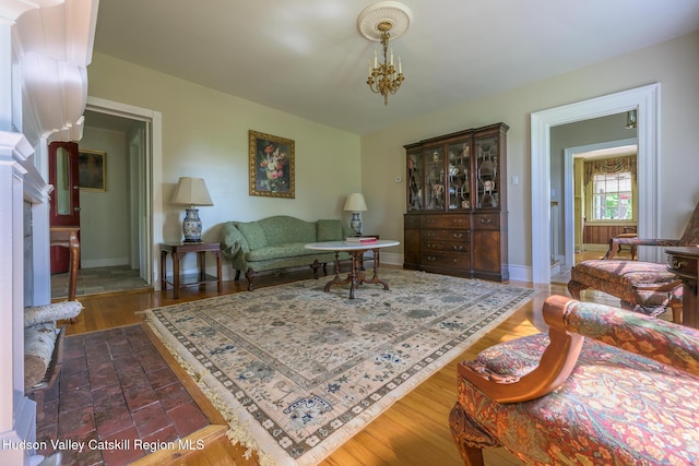 living room featuring baseboards and a chandelier