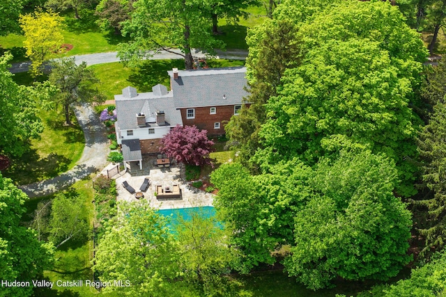 aerial view of property and surrounding area with a pool area