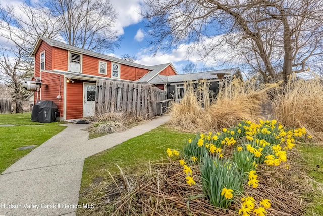 exterior space featuring fence and a front lawn