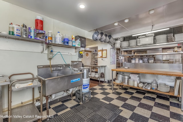 interior space featuring tile patterned floors and a sink
