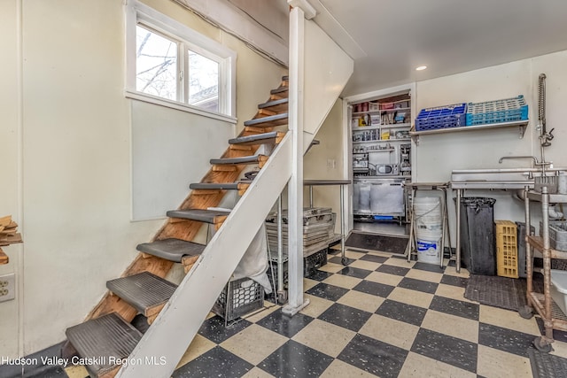 stairway featuring tile patterned floors and recessed lighting