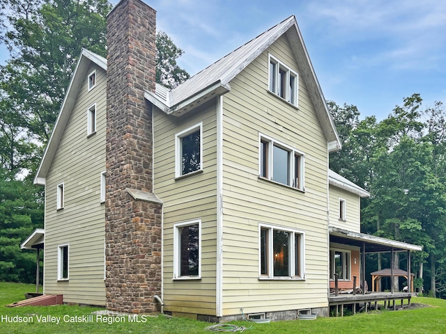 40-67 Popstone Rd, Stone Ridge, NY 12484 - view of side of home with a chimney and a yard