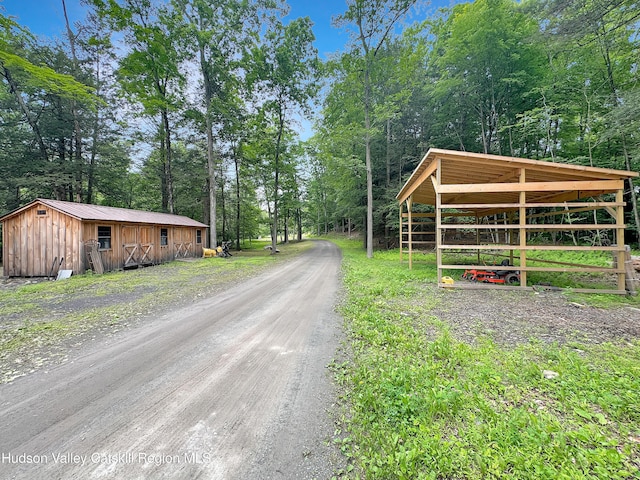 40-67 Popstone Rd, Stone Ridge, NY 12484 - view of dirt / gravel road with view of wooded area and an outbuilding