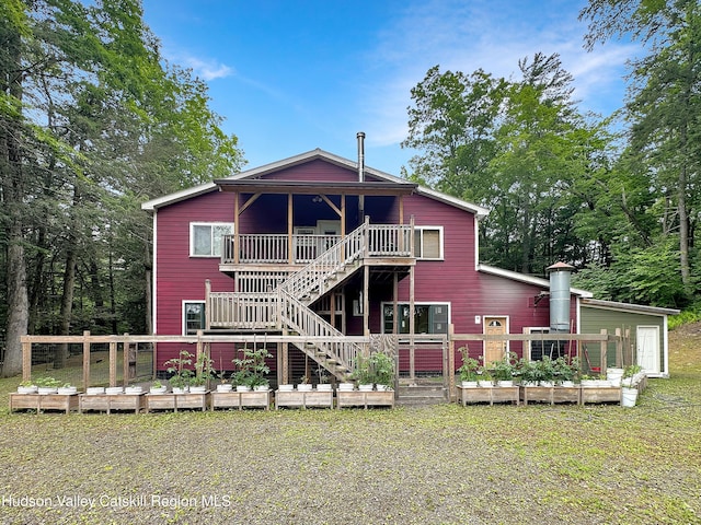 40-67 Popstone Rd, Stone Ridge, NY 12484 - rear view of property with a vegetable garden, a deck, and stairs