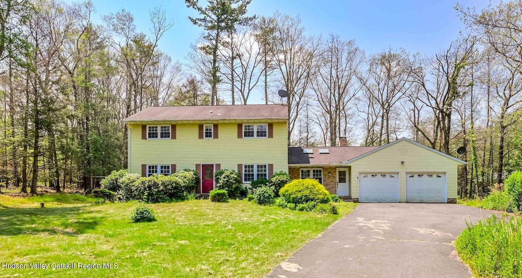 view of front of property featuring a garage and a front lawn