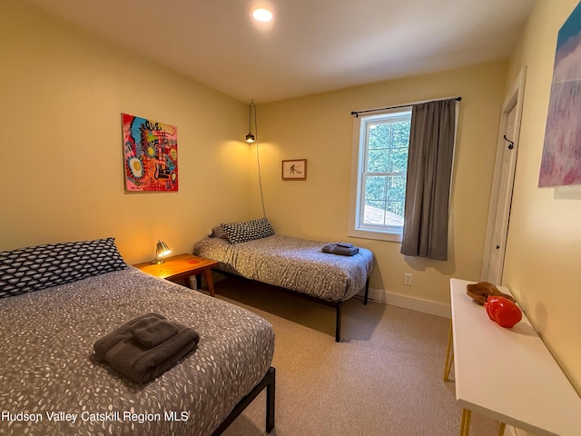 bedroom featuring carpet and baseboards