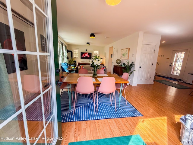 dining area with plenty of natural light and wood finished floors