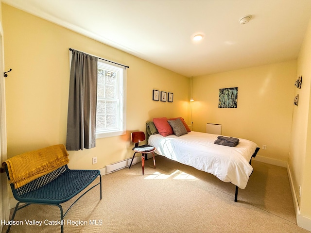 carpeted bedroom with baseboards and a baseboard radiator