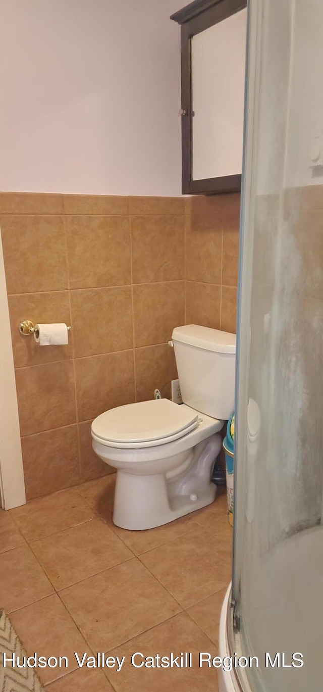 5320 Rte 23, Windham, NY 12496 - full bathroom with a stall shower, tile patterned flooring, tile walls, and a wainscoted wall