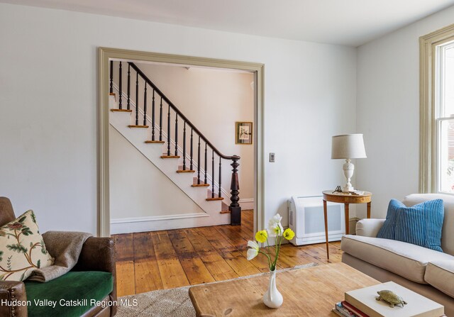 225 Robinson St, Hudson, NY 12534 - living room featuring wood-type flooring and stairway