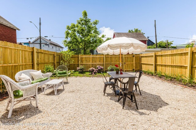225 Robinson St, Hudson, NY 12534 - fenced backyard featuring outdoor dining area and a patio area