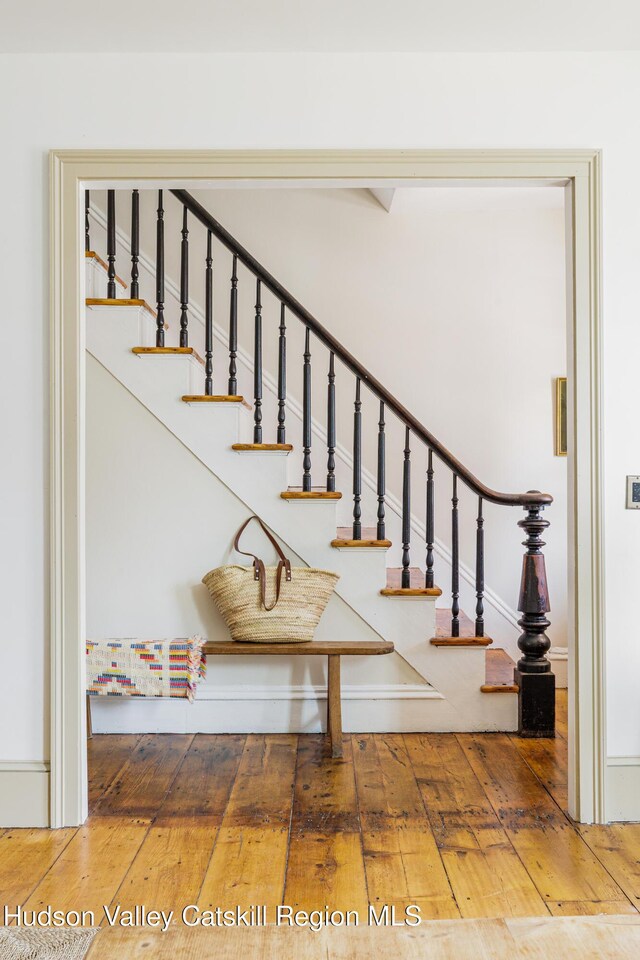 225 Robinson St, Hudson, NY 12534 - stairway featuring wood-type flooring