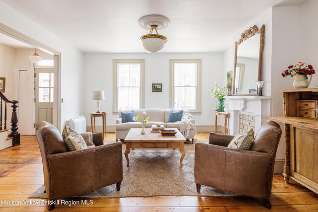 225 Robinson St, Hudson, NY 12534 - living area featuring hardwood / wood-style floors, healthy amount of natural light, and stairs