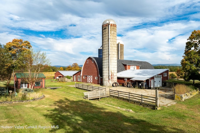 1030 County Route 27a, Ancram, NY 12502 - back of property with an outdoor structure, a chimney, a garage, a barn, and driveway