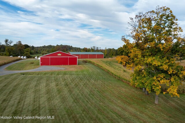 1030 County Route 27a, Ancram, NY 12502 - view of green lawn featuring an outbuilding, an outdoor structure, driveway, and a garage