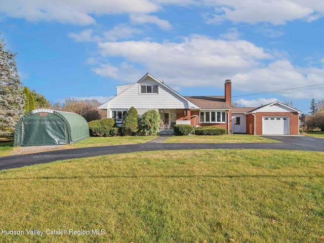 view of front of property with a front lawn and a garage