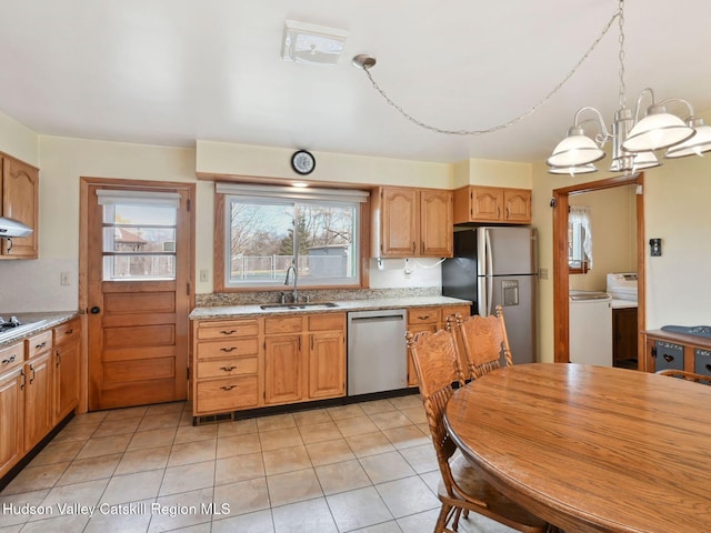 kitchen featuring sink, a notable chandelier, decorative light fixtures, light tile patterned floors, and appliances with stainless steel finishes