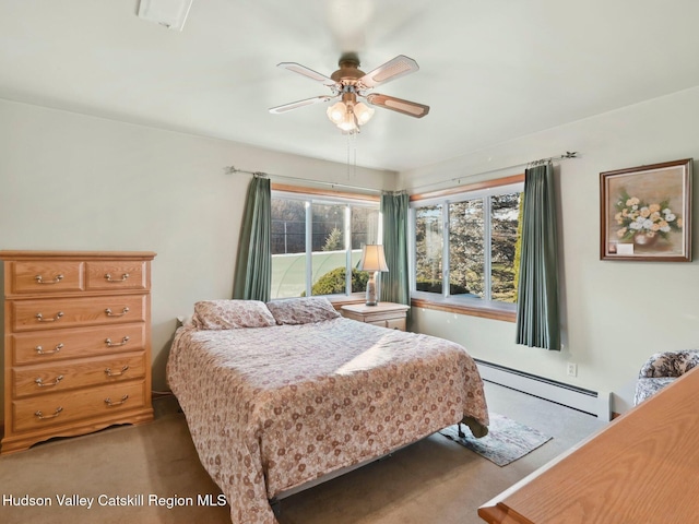 carpeted bedroom featuring ceiling fan and a baseboard radiator