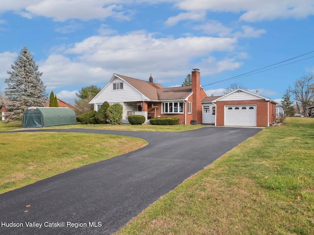 view of front of house with a front yard and a garage