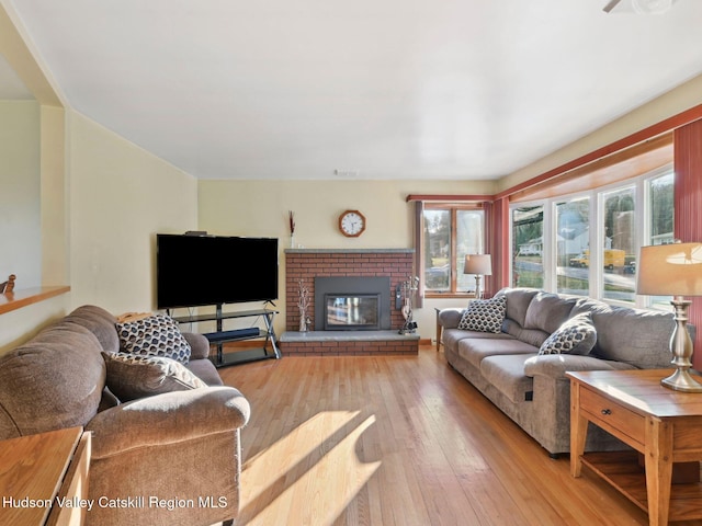 living room featuring a fireplace and light hardwood / wood-style flooring