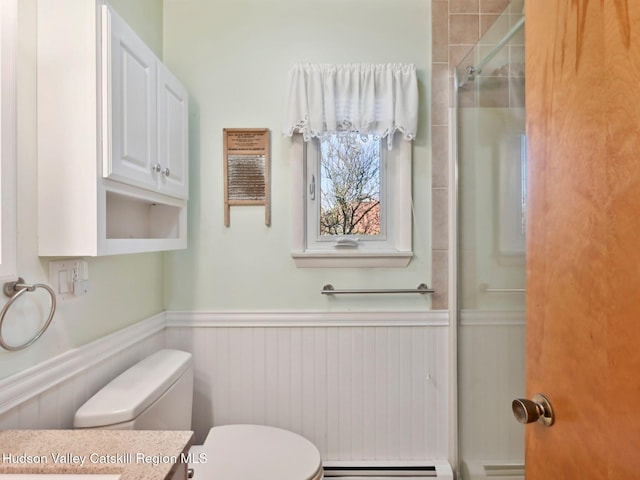 bathroom with toilet, walk in shower, and a baseboard radiator