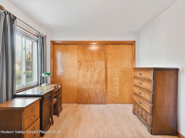 bedroom featuring a closet and light wood-type flooring