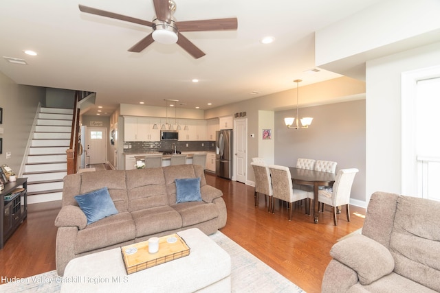 208 Hudson View Ter, Hyde Park, NY 12538 - living room featuring dark wood-type flooring, stairs, ceiling fan, a chandelier, and recessed lighting