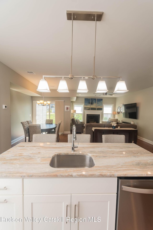 208 Hudson View Ter, Hyde Park, NY 12538 - kitchen with dishwasher, open floor plan, white cabinets, and a fireplace