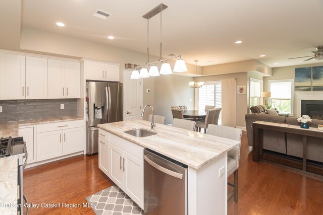 208 Hudson View Ter, Hyde Park, NY 12538 - kitchen with appliances with stainless steel finishes, backsplash, dark wood-style flooring, open floor plan, and decorative light fixtures