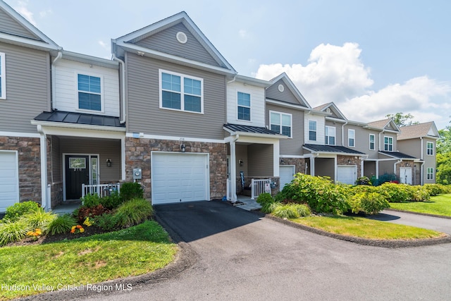 208 Hudson View Ter, Hyde Park, NY 12538 - multi unit property featuring a standing seam roof, stone siding, an attached garage, asphalt driveway, and a metal roof