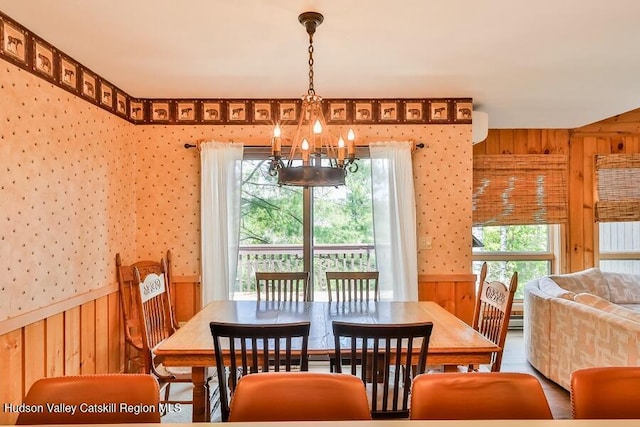 111 Brainard Ridge Rd Unit 11B, Windham, NY 12496 - dining space featuring a chandelier, wallpapered walls, wooden walls, and wainscoting