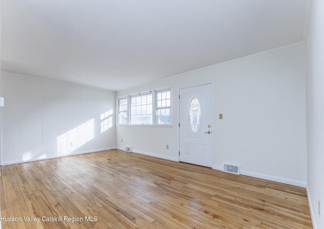 foyer entrance featuring light wood-type flooring and ornamental molding