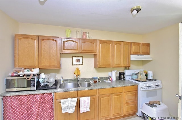 kitchen featuring white gas range and sink