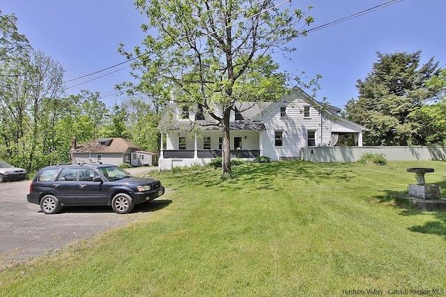 view of front of house featuring a front yard and covered porch