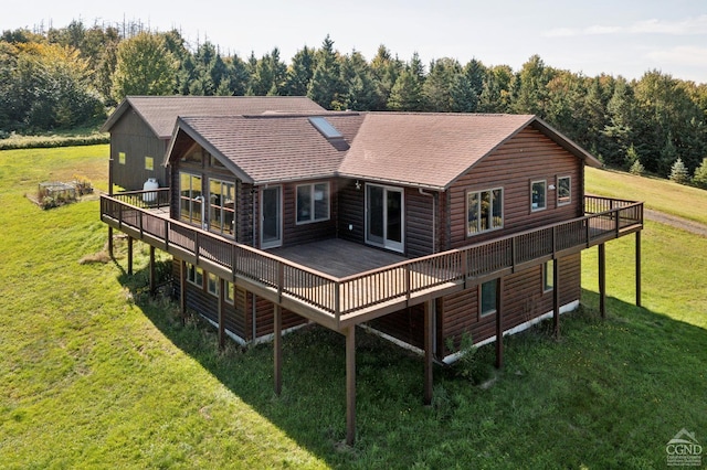 187 Mt Jeffereson Rd, Jefferson, NY 12167 - back of property featuring a deck, roof with shingles, a lawn, and a view of trees