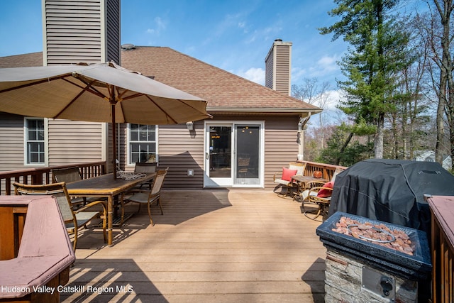 wooden terrace featuring outdoor dining area
