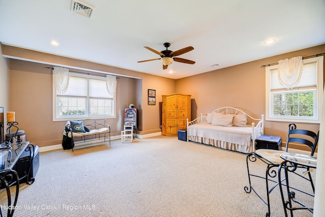 carpeted bedroom with ceiling fan, baseboards, visible vents, and recessed lighting