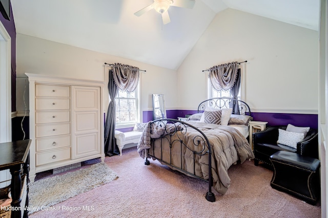 carpeted bedroom featuring high vaulted ceiling and ceiling fan
